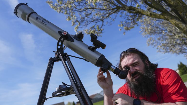 Kenny Riehl, of Solon, Iowa, adjusts a telescope while looking at the sun before a total solar eclipse, Monday, April 8, 2024, in Trenton, Ohio.