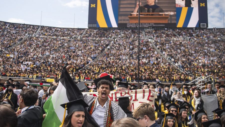 Rawan Antar, 21, center, chants in support of Palestinians during the University of Michigan's Spring 2024 Commencement Ceremony at Michigan Stadium in Ann Arbor, Mich., on Saturday, May 4, 2024. (Katy Kildee/Detroit News via AP)