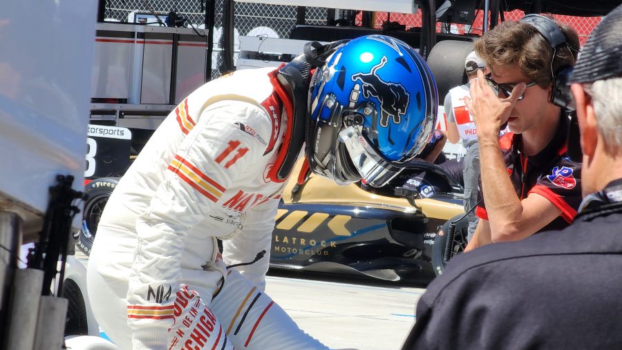 Nolan Allaer, 22, of Grosse Pointe Woods, wears a Detroit Lions-themed race helmet as he climbs into his car at the Detroit Grand Prix.