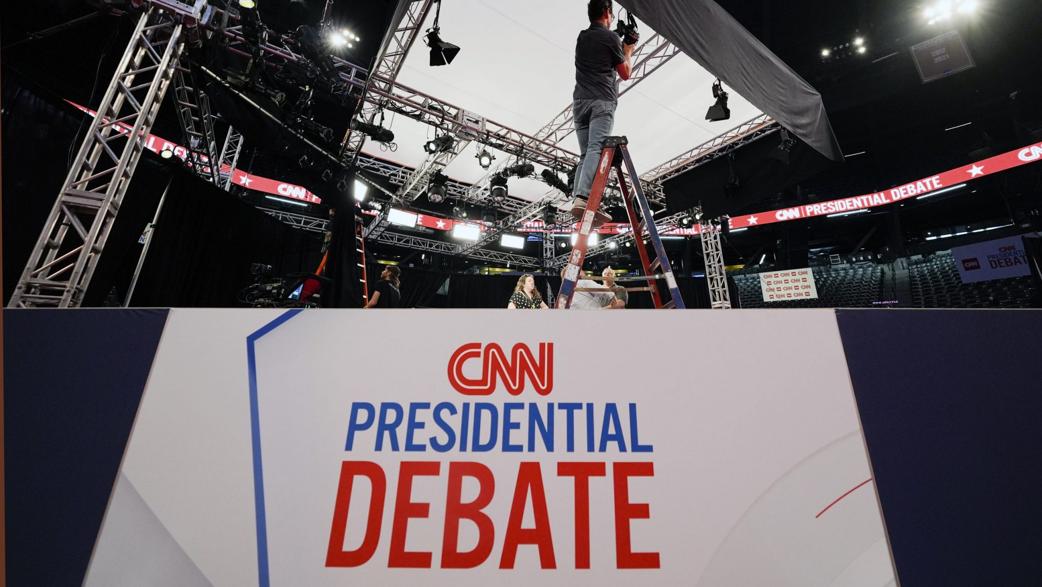 FILE - Ben Starett, lighting programmer for CNN, sets up lights in the spin room for the presidential debate between President Joe Biden and Republican presidential candidate former President Donald Trump in Atlanta, Wednesday, June 26, 2024.