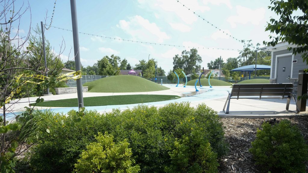 Police perimeter tape wraps around a pole at Brooklands Plaza Splash Pad on Monday, June 17, 2024, in Rochester Hills, Mich.