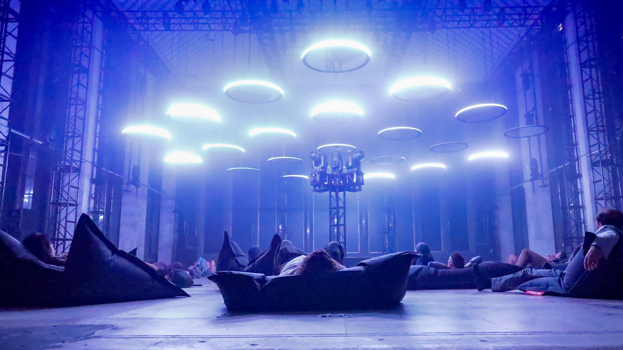 Attendees of the "SKALAR: Reflections on Light and Sound" art installation at 1001 Woodward Ave in Detroit watch the light show on June 12, 2024.