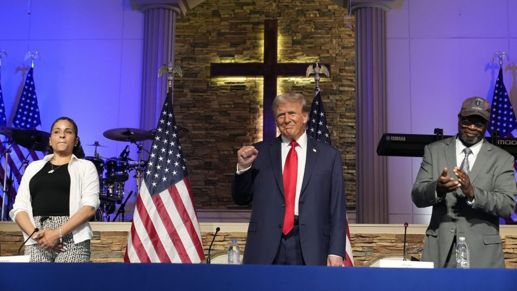 Republican presidential candidate former President Donald Trump arrives to speak at a campaign event at 180 Church, Saturday, June 15, 2024, in Detroit, as Itasha Dotson and Carlos Chambers listen.