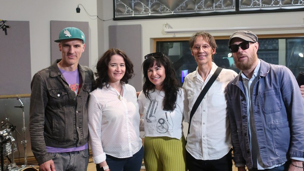 WDET Alternate Take host Liz Warner posing with the band Infinite River.