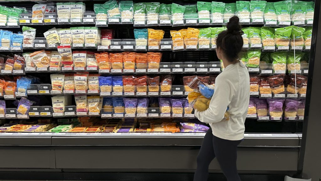 File - A shopper peruses cheese offerings at a Target store on Oct. 4, 2023, in Sheridan, Colo. Inflation is easing slightly, but grocery prices are still high. (AP Photo/David Zalubowski, File)