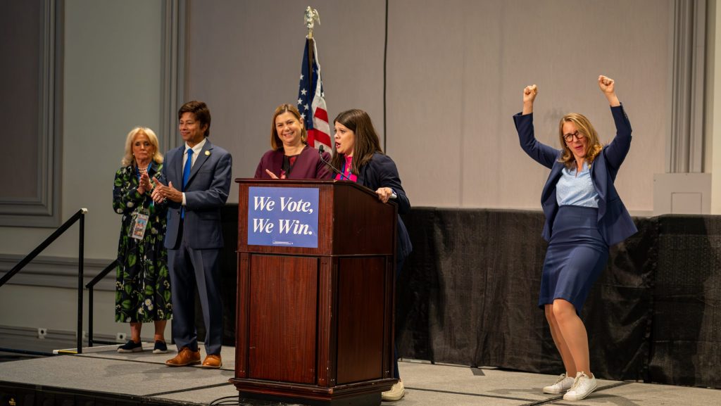 Michigan Congresswoman Haley Stevens stands at the podium alongside fellow members of Michigan's Democratic Congressional Delegation at the Democratic National Convention in Chicago.