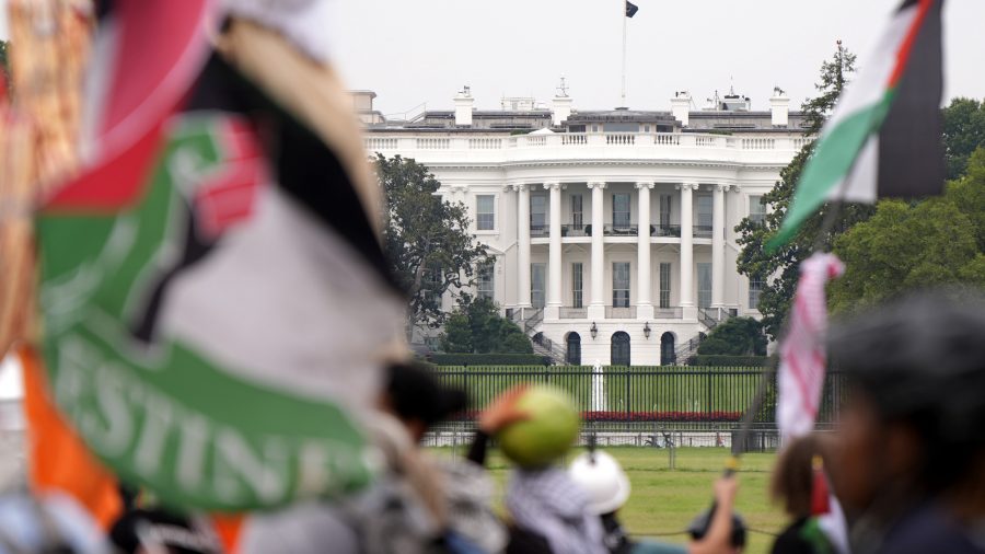 Demonstrators pass the White House during a protest against the visit of Israeli Prime Minister Benjamin Netanyahu to the White House, Thursday, July 25, 2024, in Washington.