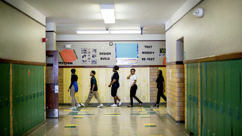 Detroit Public Schools students walk through a school hallway.