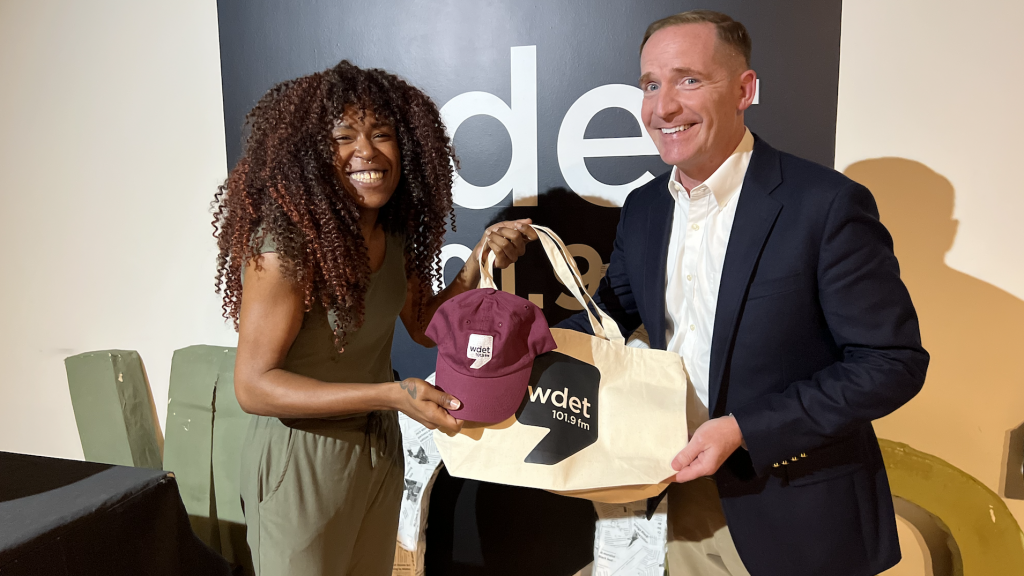 Comedian and actor Marc Evan Jackson poses with some WDET swag alongside Tia Graham, host of "The Metro," on Tuesday, Sept. 17, 2024.