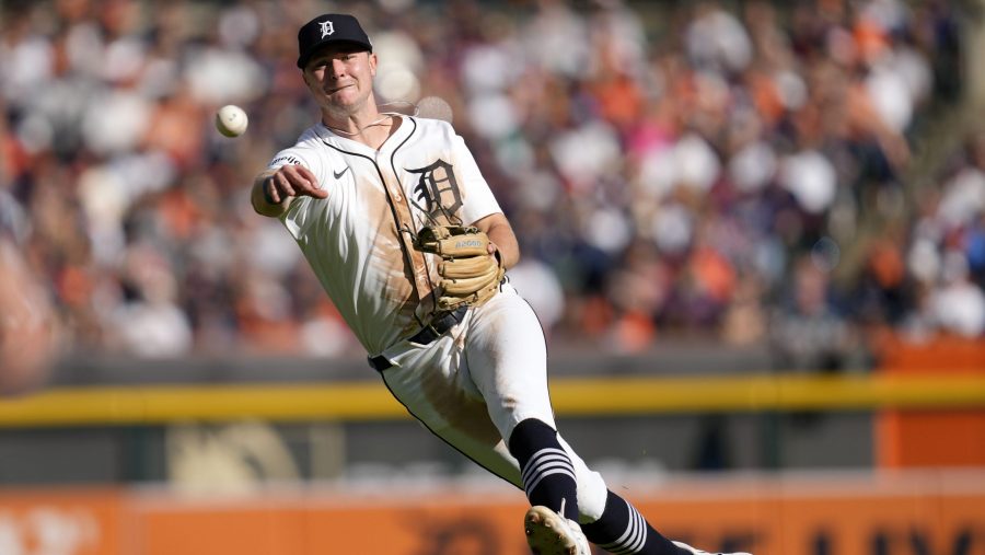 Detroit Tigers shortstop Trey Sweeney throws errantly to first base on a single by Cleveland Guardians' Steven Kwan in the third inning during Game 3 of a baseball American League Division Series, Wednesday, Oct. 9, 2024, in Detroit.