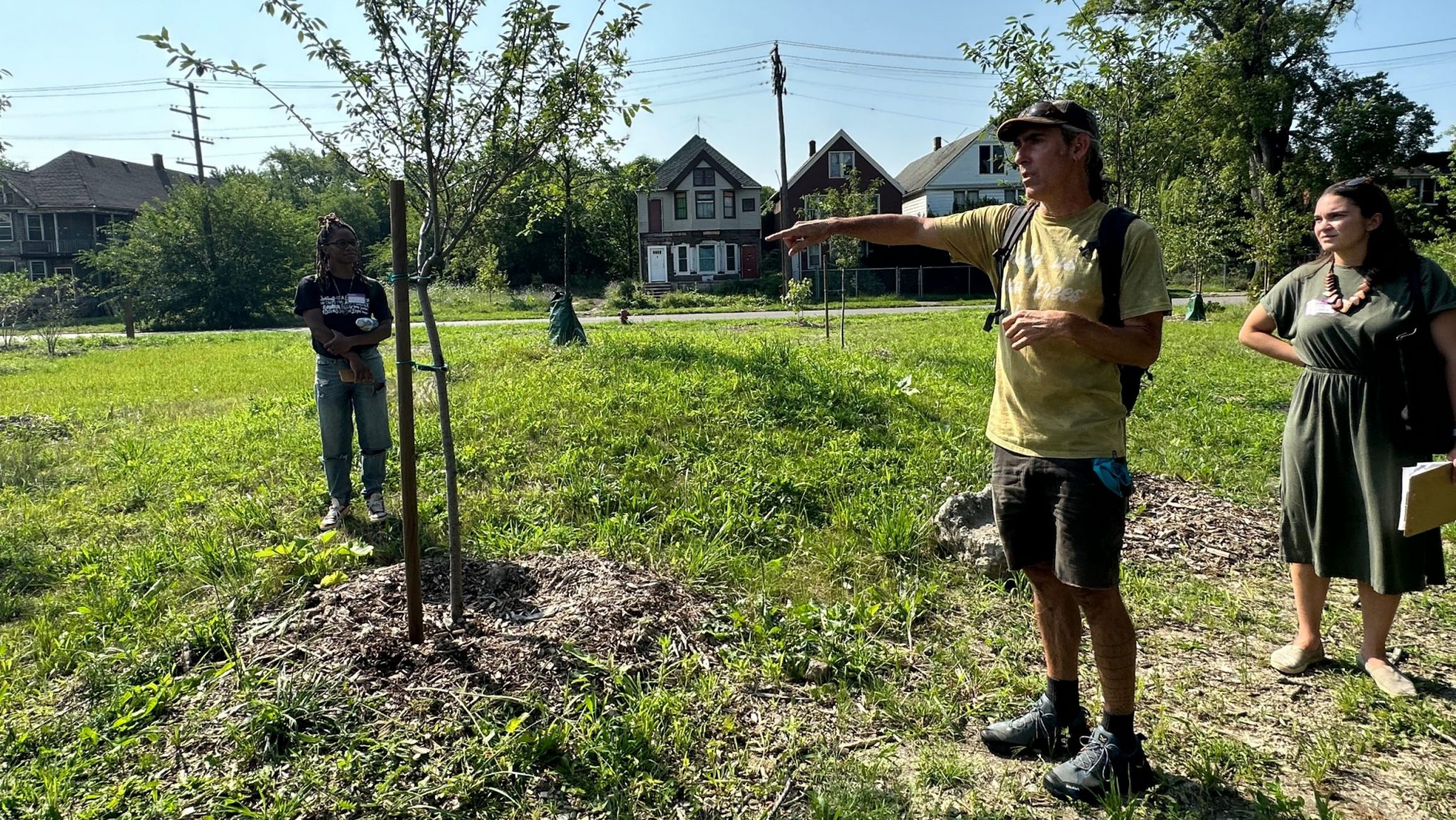 Birch Kemp (center), executive director of Arboretum Detroit, gives a tour of Circle Forest in Detroit's Poletown East neighborhood.