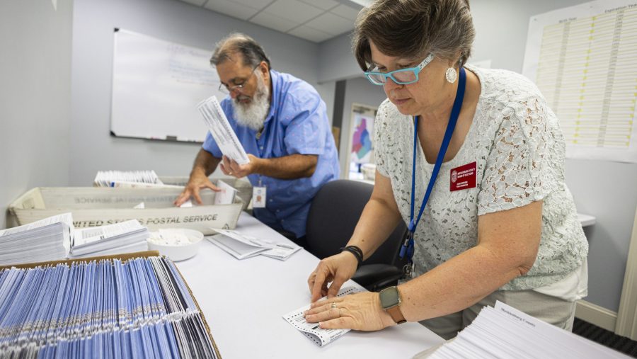 FILE - Dawn Stephens, right, and Duane Taylor prepare ballots to be mailed at the Mecklenburg County Board of Elections in Charlotte, N.C., Sept. 5, 2024.