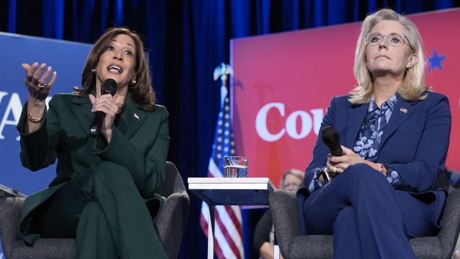 Democratic presidential nominee Vice President Kamala Harris speaks as former Republican Congresswoman Liz Cheney listens during a town hall at the Royal Oak Theatre in Royal Oak, Mich., Monday, Oct. 21, 2024.