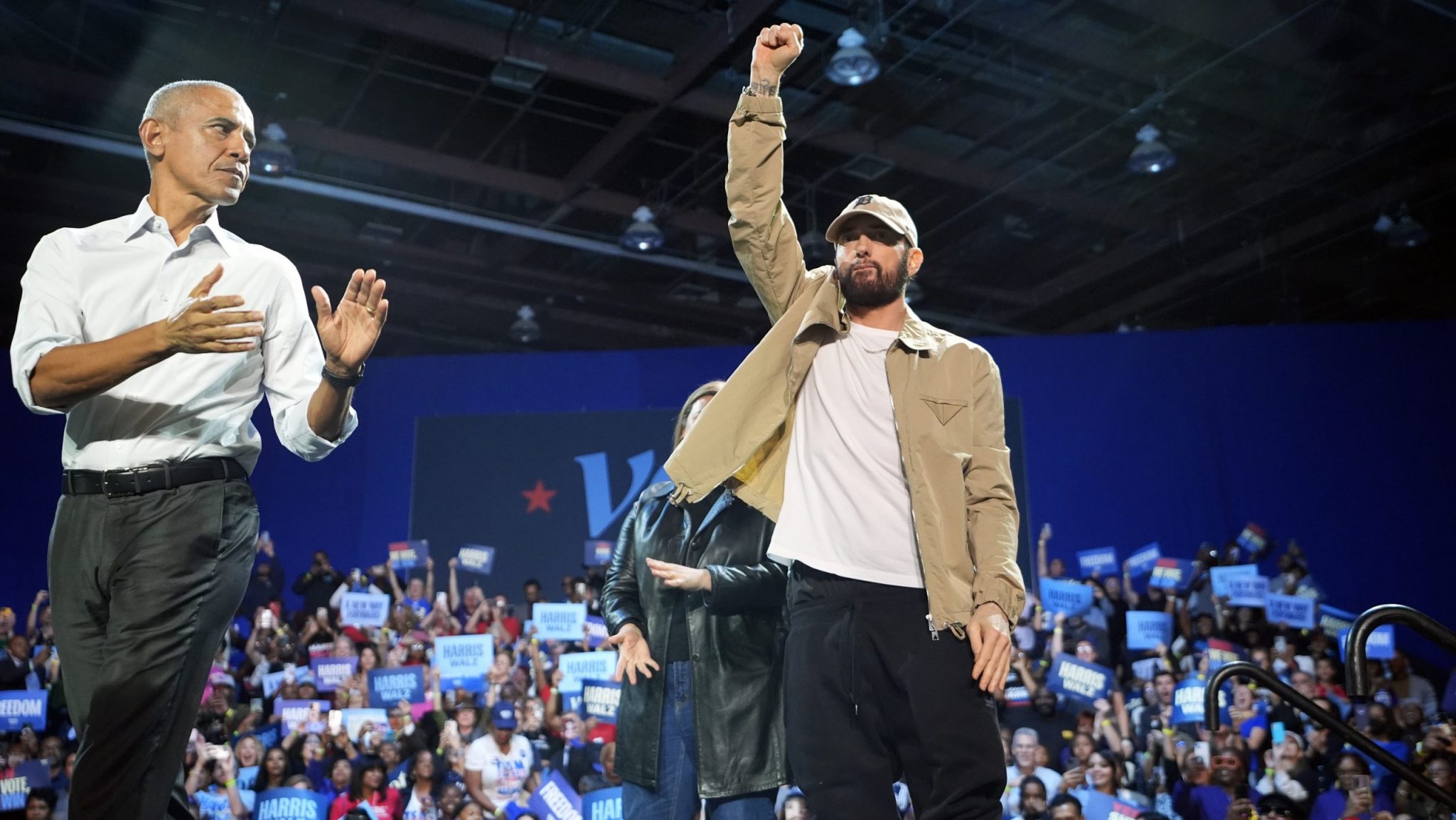 Rapper Eminem, center, greets the crowd on stage with former President Barack Obama, left, at a campaign rally supporting Democratic presidential nominee Vice President Kamala Harris, Tuesday, Oct. 22, 2024, in Detroit.