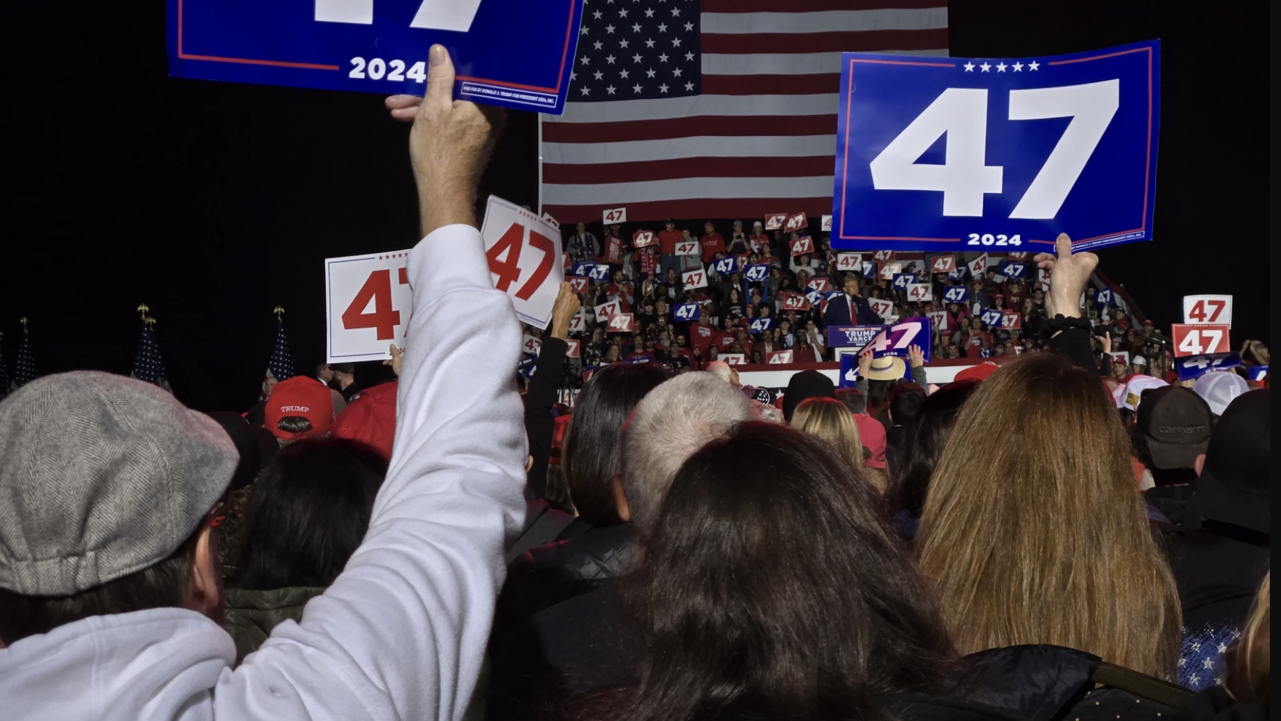 A crowd watches Republican former President Donald Trump speak at a rally in Novi as he campaigns for another term.