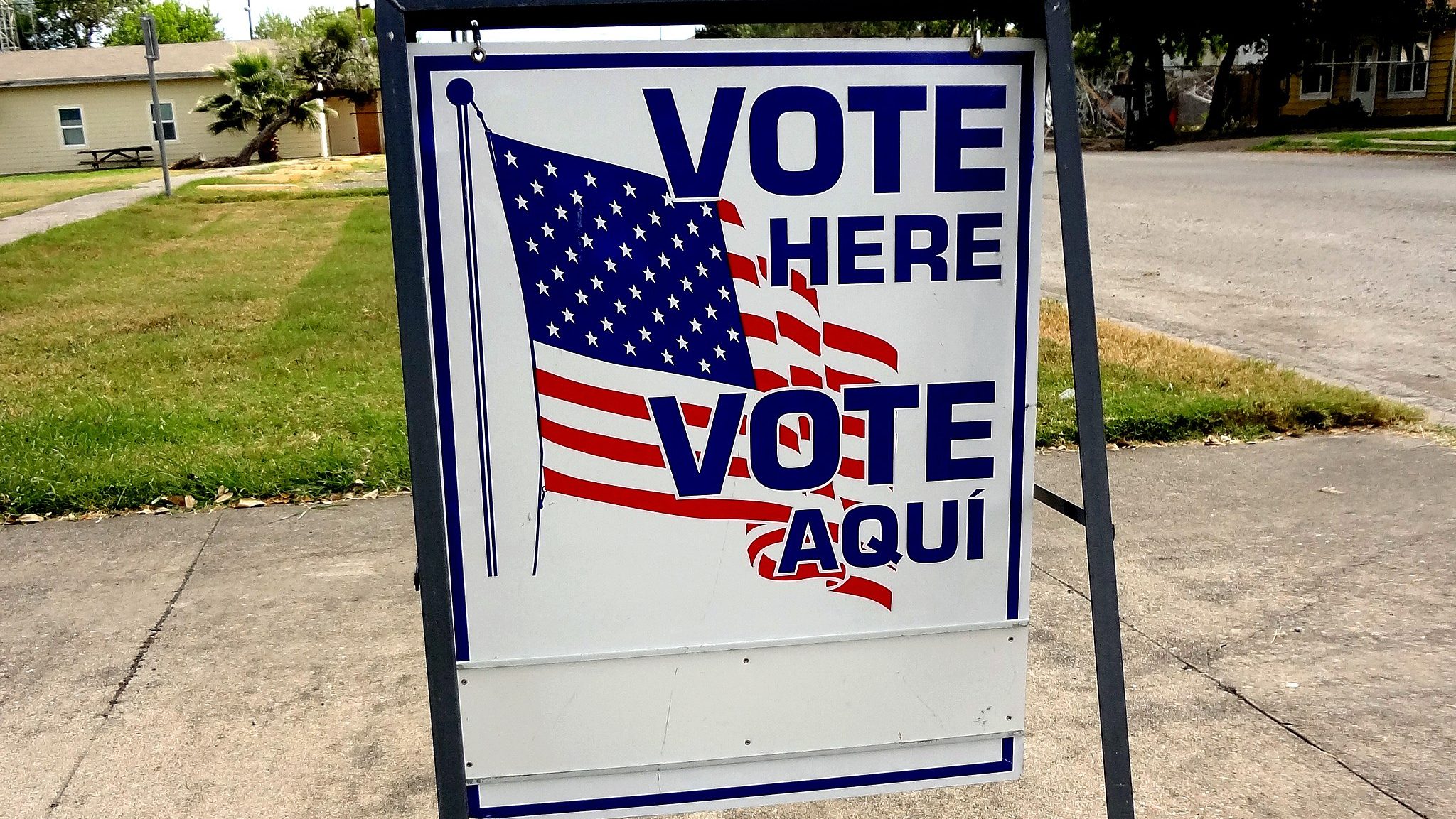 A "vote here" sign outside a polling place.