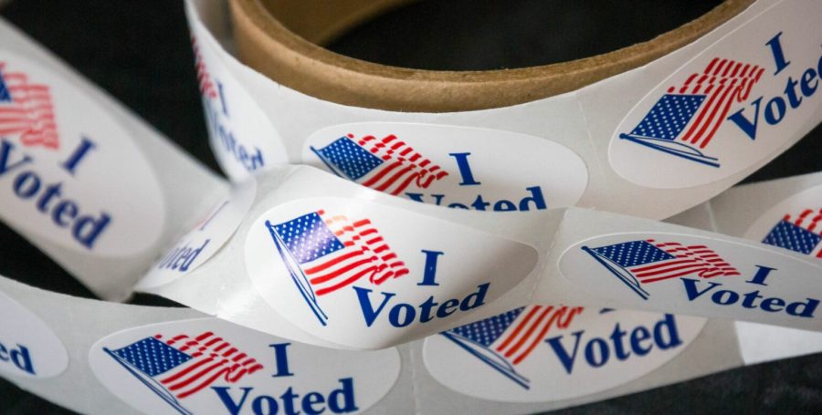A role of I Voted stickers unraveled on a table.