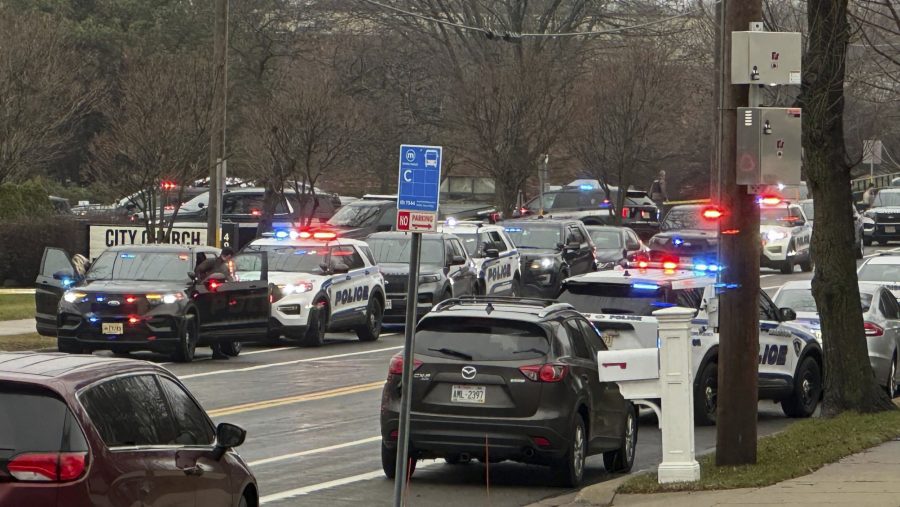 Emergency vehicles are parked outside the Abundant Life Christian School in Madison, Wis., where multiple injuries were reported following a shooting, Monday, Dec. 16, 2024.