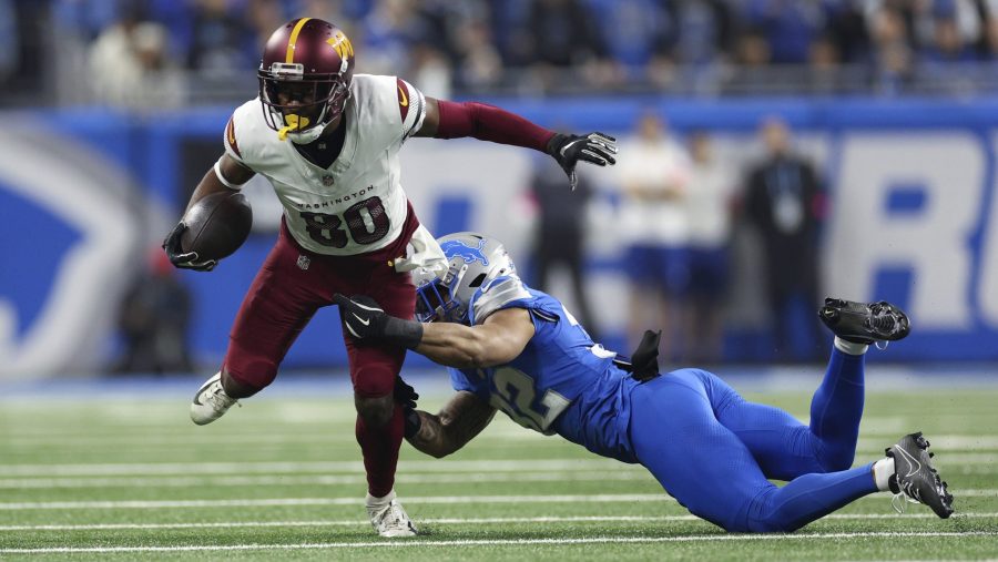 Washington Commanders wide receiver Jamison Crowder (80) breaks the tackle of Detroit Lions safety Brian Branch (32) during the first half of an NFL football divisional playoff game, Saturday, Jan. 18, 2025, in Detroit.