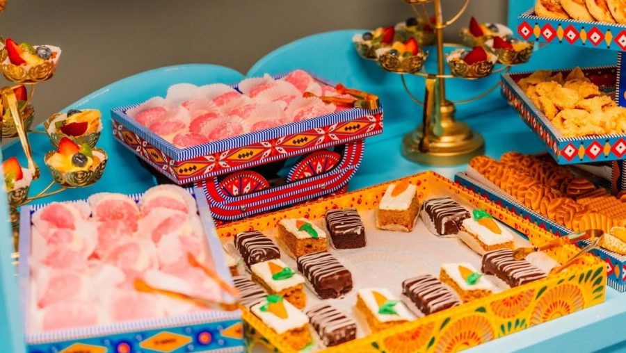Brightly colored cookies and snacks on a mobile tea cart