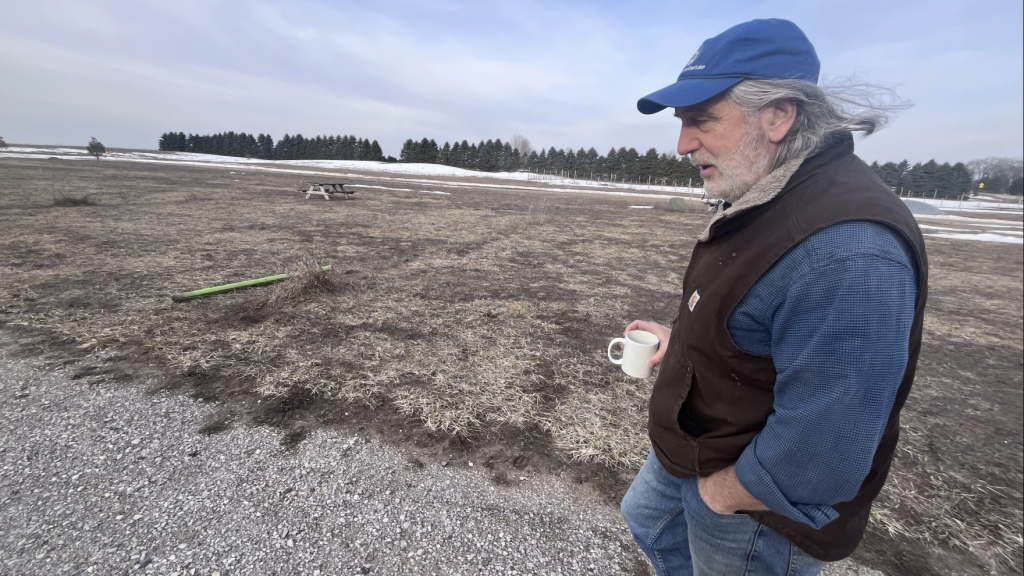 Jim Lively has a local food market just minutes from the Sleeping Bear Dunes National Lakeshore in northern Michigan. He’s waiting for the federal money he was promised so he can put solar on the roof and offset the costs of opening up a campsite for RVs in this field.