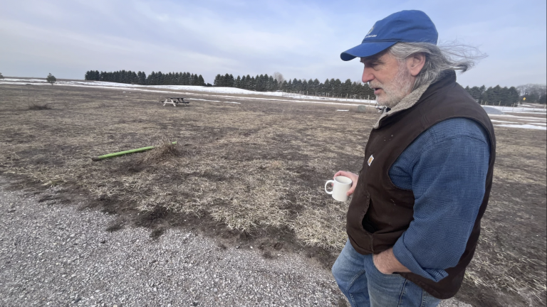 Jim Lively has a local food market just minutes from the Sleeping Bear Dunes National Lakeshore in northern Michigan. He’s waiting for the federal money he was promised so he can put solar on the roof and offset the costs of opening up a campsite for RVs in this field.