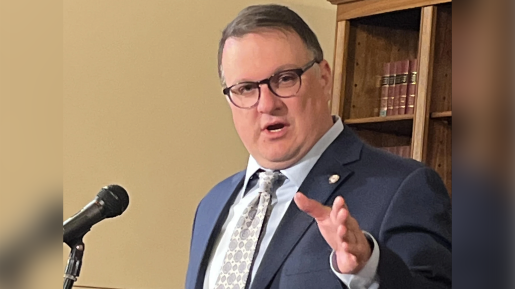 House Speaker Matt Hall stands at a podium.