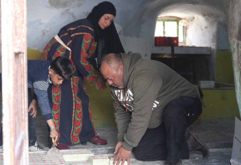 A Palestinian family making Nabulsi soap at home in Mazre' Al-Nobani village in the West Bank.