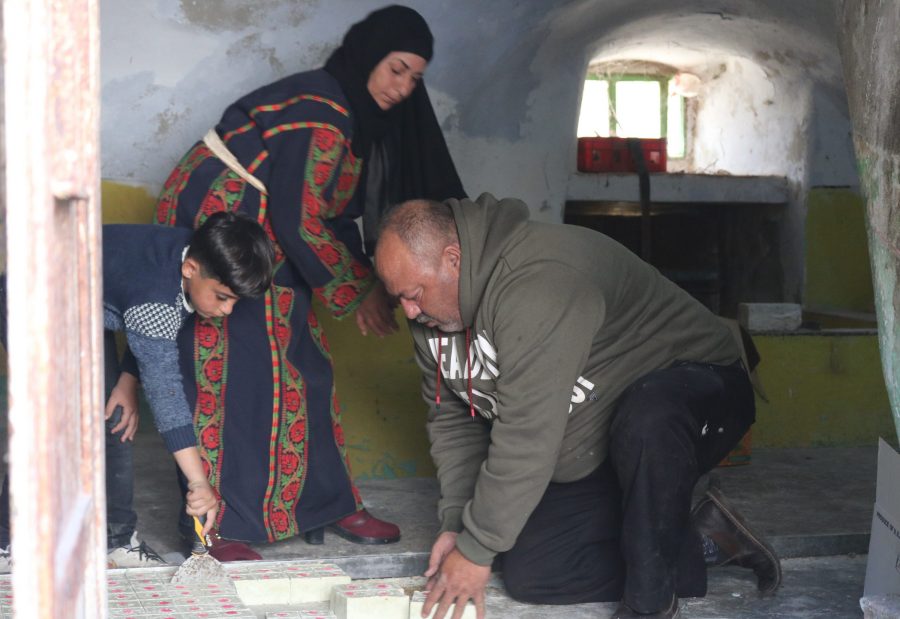 A Palestinian family making Nabulsi soap at home in Mazre' Al-Nobani village in the West Bank.