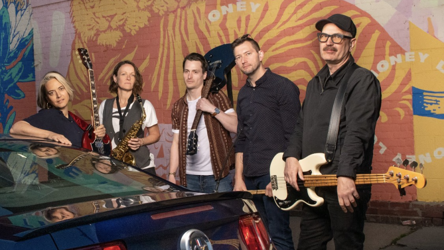 Elspeth Tremblay and the Treatment pose with their instruments