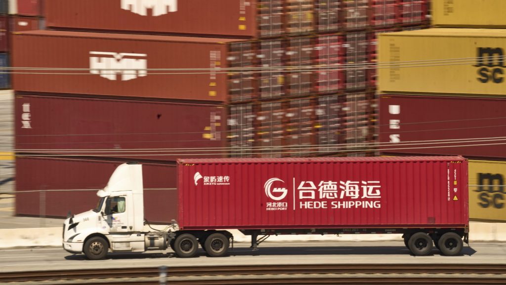 A truck carrying a Hede (Hong Kong) International Shipping Co., Ltd., container moves along the Port of Los Angeles Wednesday, April 9, 2025 in Los Angeles.