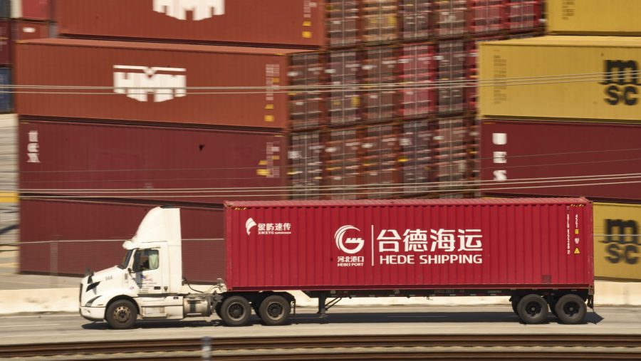 A truck carrying a Hede (Hong Kong) International Shipping Co., Ltd., container moves along the Port of Los Angeles Wednesday, April 9, 2025 in Los Angeles.