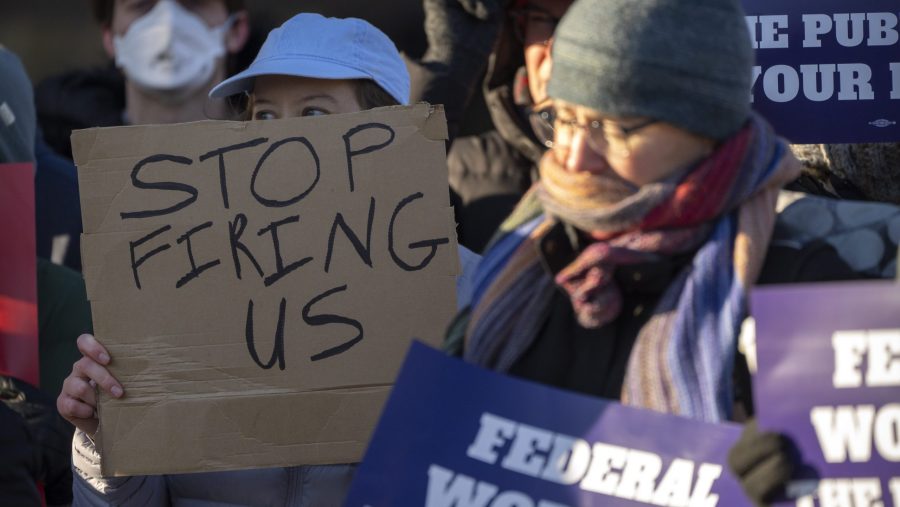FILE - Demonstrators rally in support of federal workers outside of the Department of Health and Human Services, Feb. 14, 2025, in Washington.