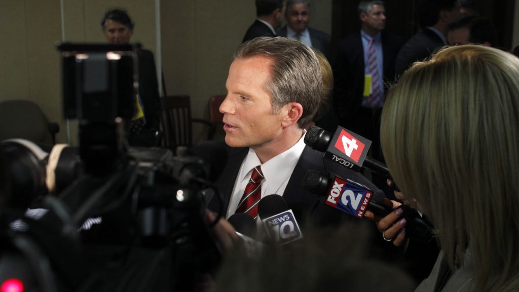 FILE - Republican gubernatorial candidate, Michigan Attorney General Mike Cox, talks to reporters following a debate, on April 21, 2010, in East Lansing.