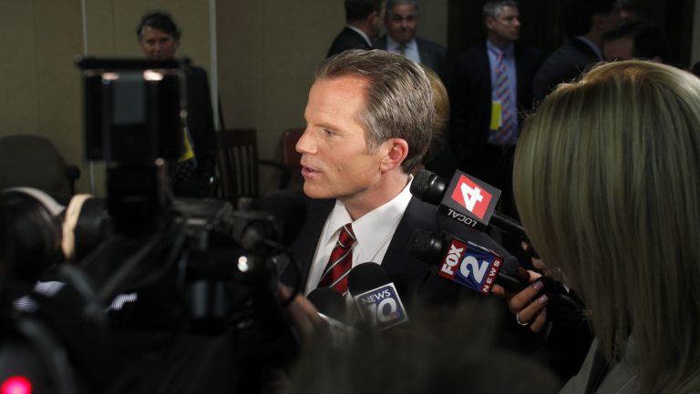 FILE - Republican gubernatorial candidate, Michigan Attorney General Mike Cox, talks to reporters following a debate, on April 21, 2010, in East Lansing.