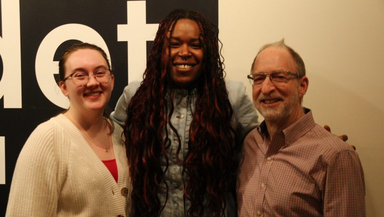 WDET intern Natalie Albrecht and Metro co-host Tia Graham pose with Neil Rubin, honorary chairperson of Bookstock, at WDET Studios.