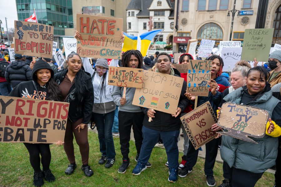 Students from Marygrove High School pose with their signs during the #HandsOff protest in Detroit on April 5, 2025.