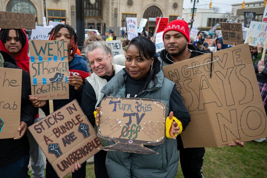 Students from Marygrove High School pose with their signs during the #HandsOff protest in Detroit on April 5, 2025.