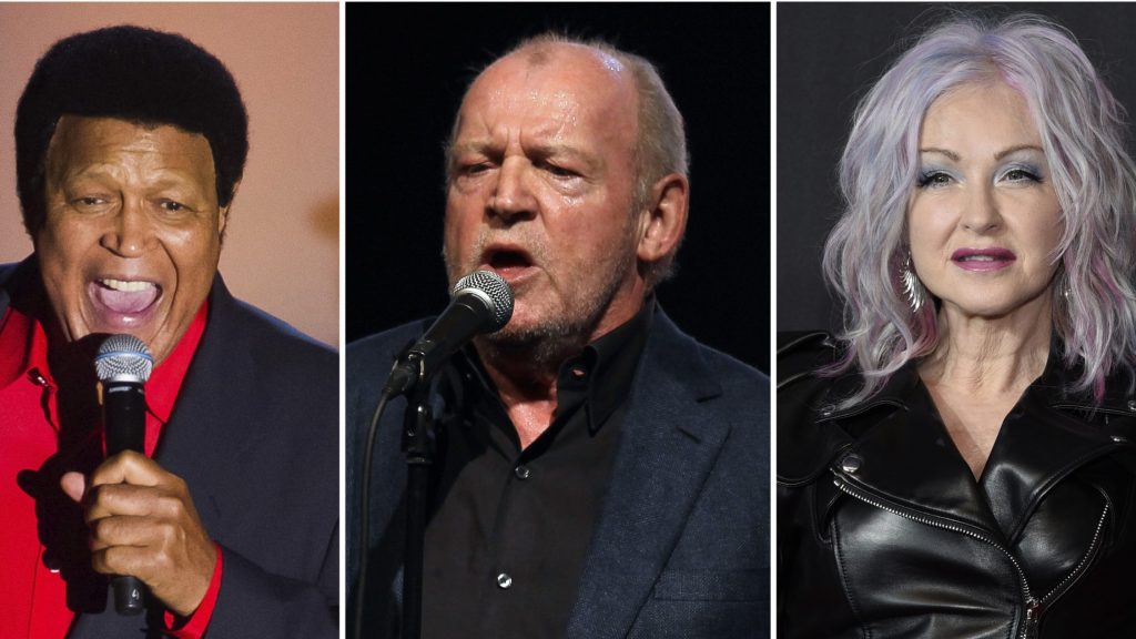 This combination of photos shows Cubby Checker at the Songwriters Hall of Fame Awards in New York on June 12, 2014, left, British singer Joe Cocker performing in Monaco on Aug. 5, 2011, center, and Cyndi Lauper at the MTV Video Music Awards in New York on Sept. 12, 2021.
