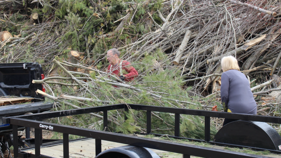 Terry and Nancy Chamberlin drop off yet another load of wooden debris from their property in Alanson on April 25, 2025.