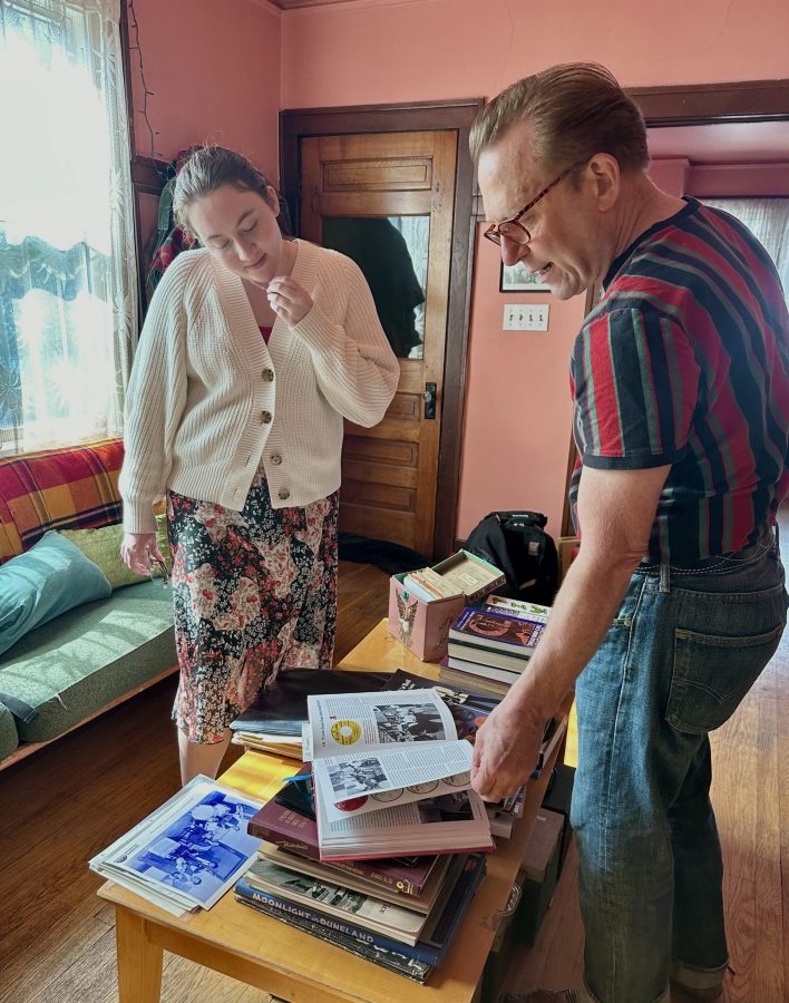 Michael Hurtt looks through his book with Natalie Albrecht.