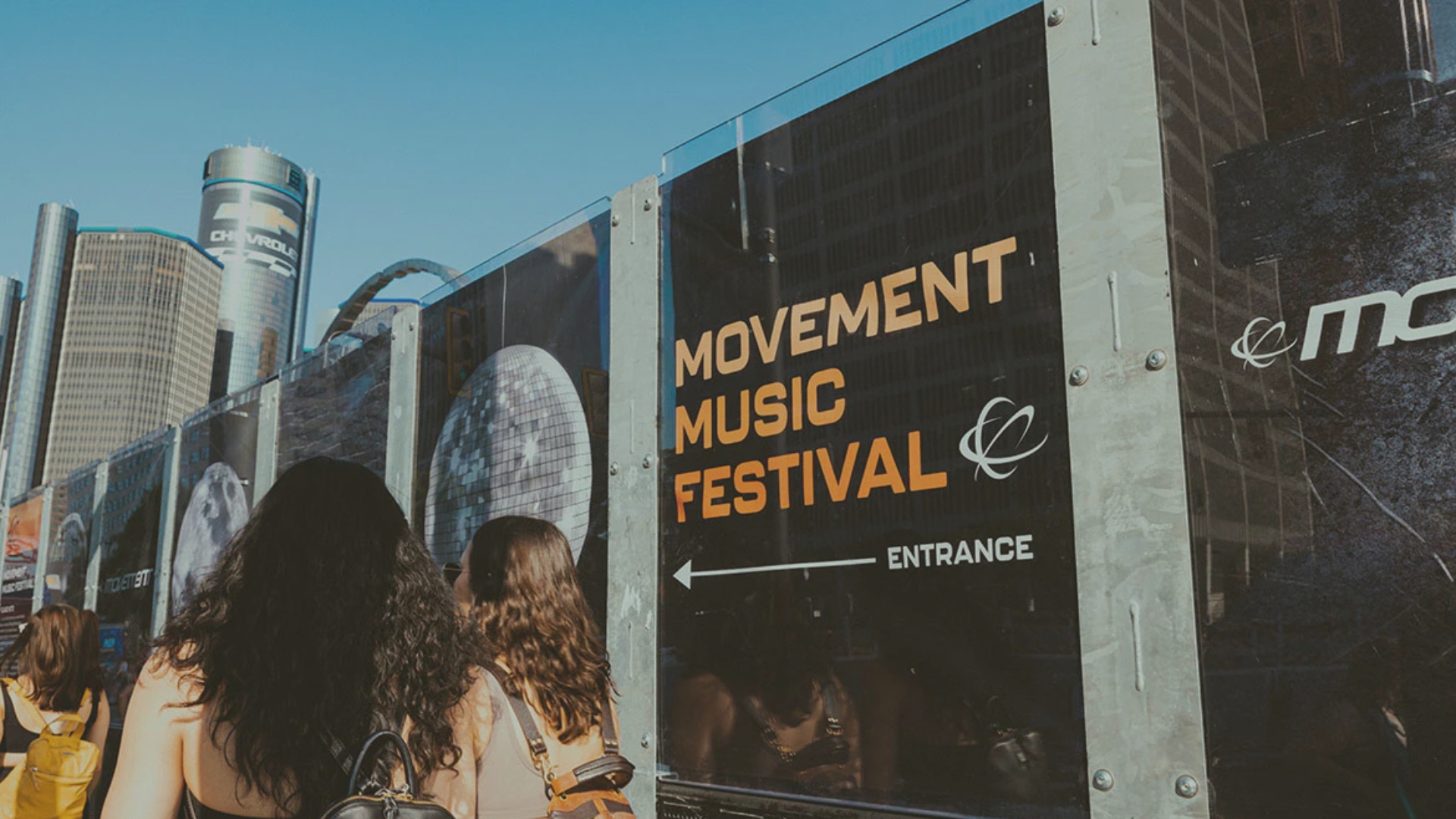 People entering the Music Festival. The Renaissance Center is i the background.