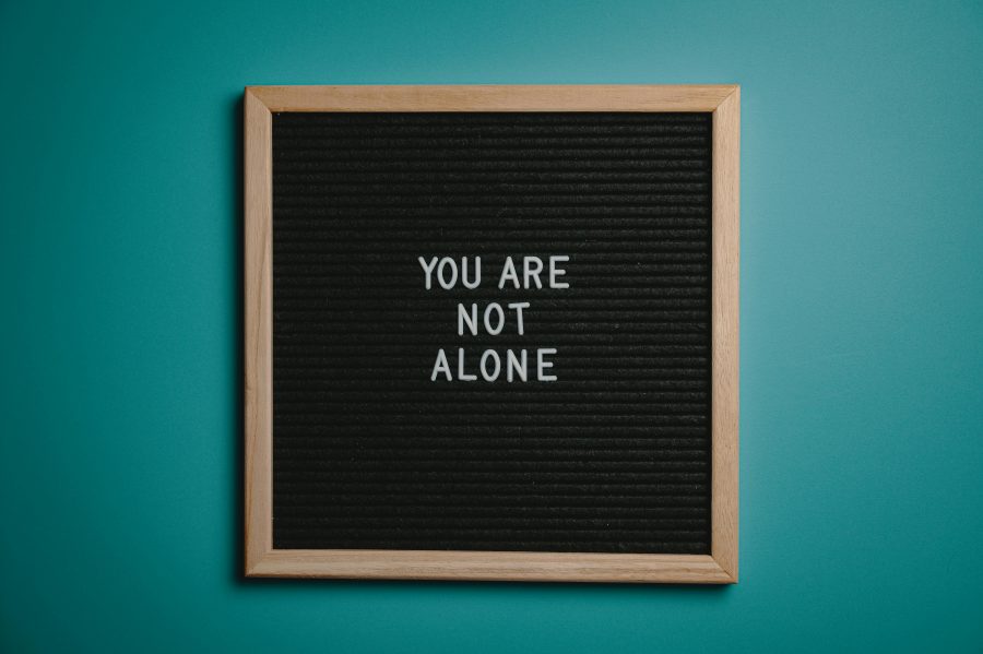 A sign reads "You are not alone"