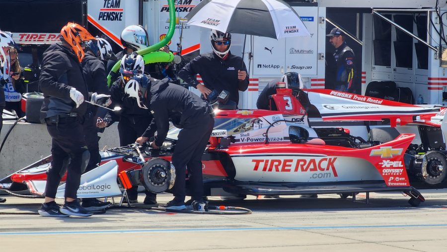 The Team Penske pit crew works on Scott McLaughin's car on pit road.