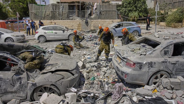 Israeli soldiers work amid the rubble of residential buildings destroyed by an Iranian missile strike that killed several people, in Beersheba, Israel, on Tuesday, June 24, 2025.