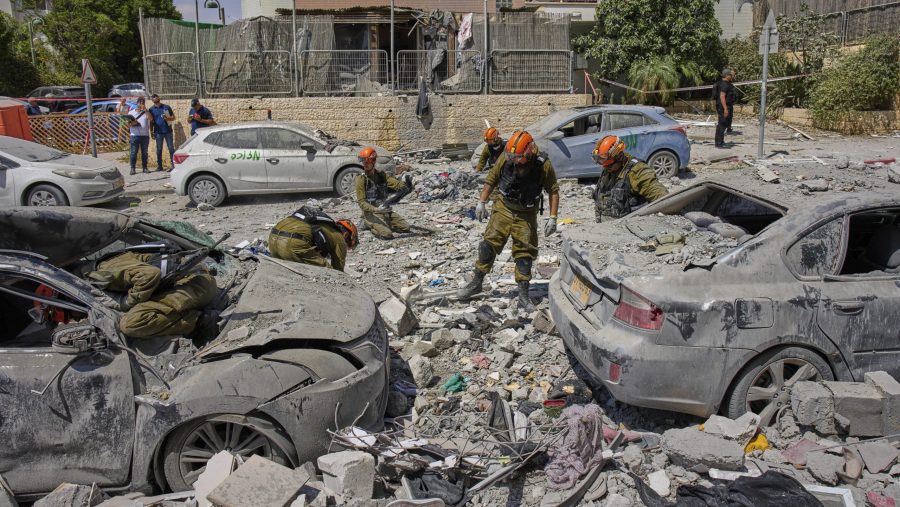 Israeli soldiers work amid the rubble of residential buildings destroyed by an Iranian missile strike that killed several people, in Beersheba, Israel, on Tuesday, June 24, 2025.