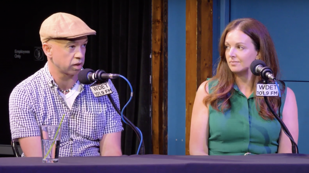 Michigan political consultant and co-host of the Baldly Bipartisan podcast Adrian Hemond (left) and Resch Strategies Vice President Anna Heaton (right) appear on MichMash, recorded live from the Go Comedy! Improv Theater in Ferndale.