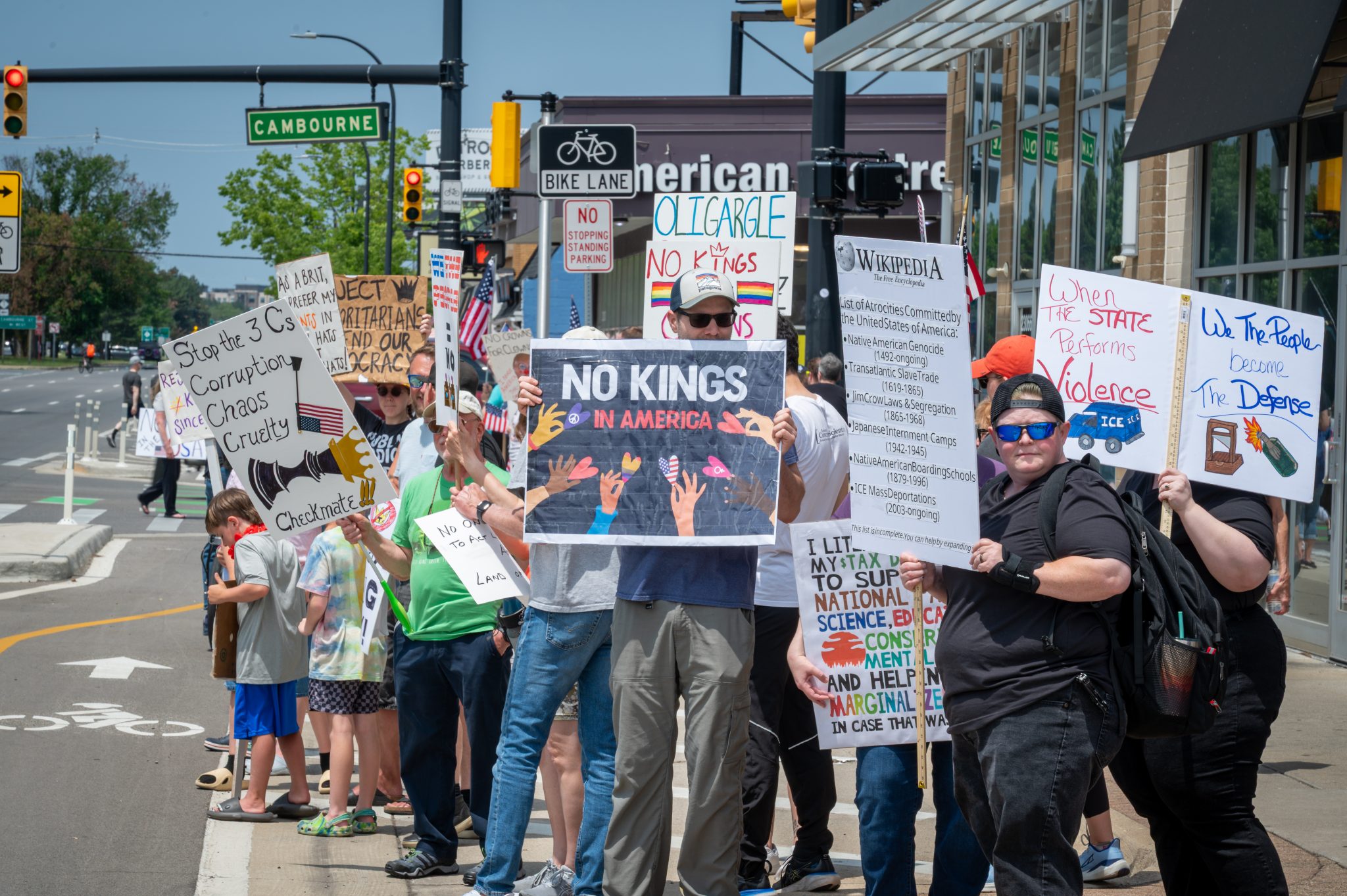Protesters hold signs against corruption, oligarchy, violence, deportations and more in Ferndale.