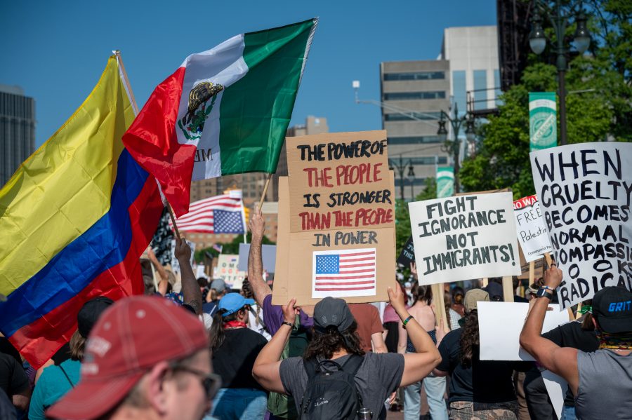 Detroiters gather to protest with homemade signs and flags.