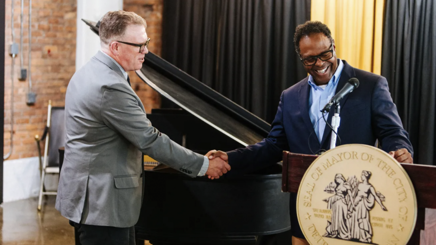Detroit Composer Laureate Patrick Prouty shakes hands with then Deputy Mayor Todd Bettison during Prouty's appointment announcement, Sept. 5, 2024.